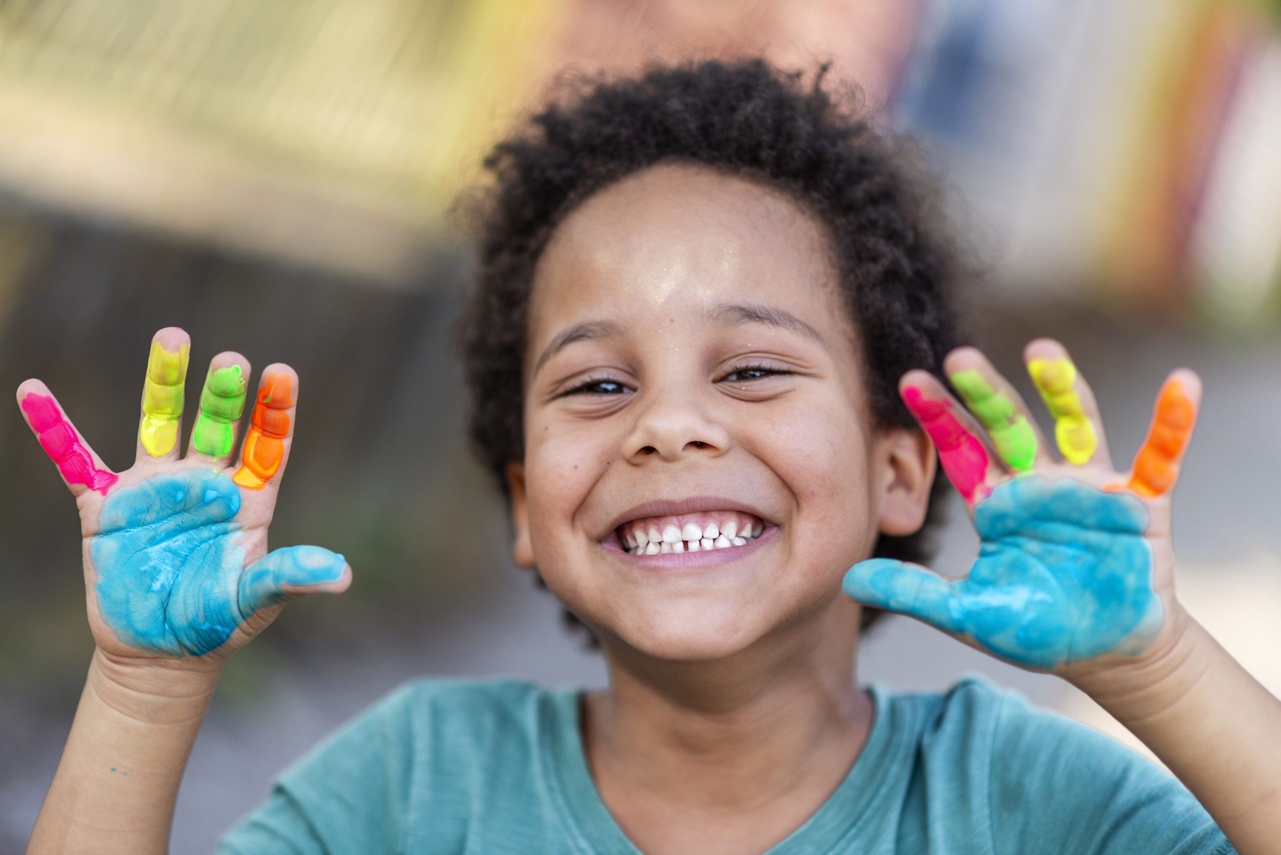 The child faces the Camera with the Painting in hand