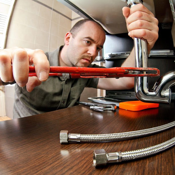 plumber portrait of caucasian plumber at work